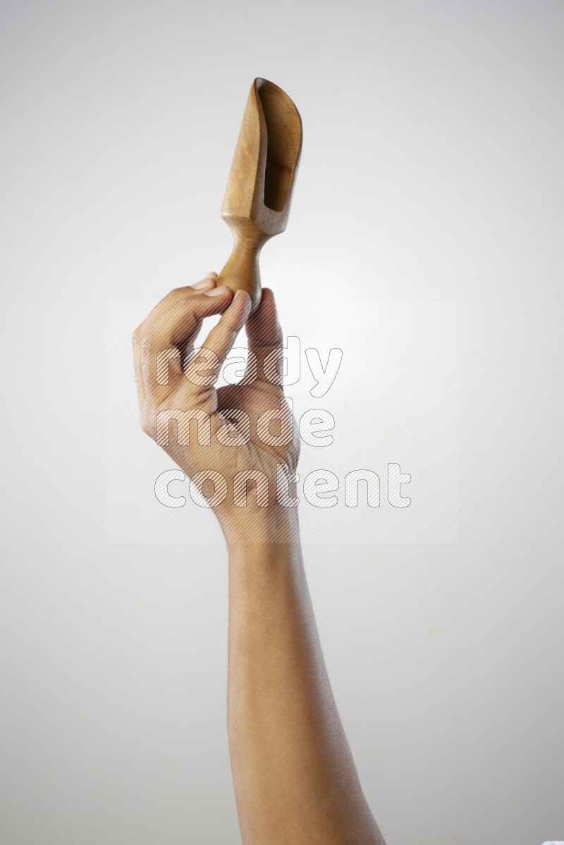 Male Hand Holding Wooden scoop