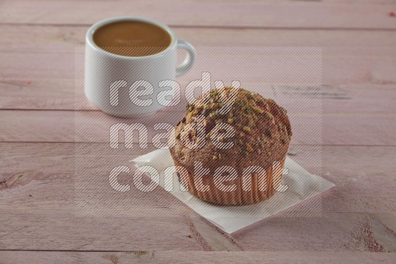 Pistachio cupcake on a wooden pink background