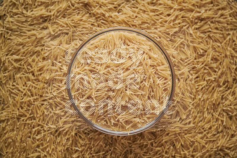 Vermicelli pasta in a glass bowl on black background