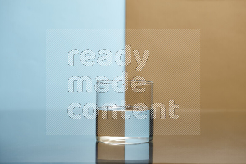 The image features a clear glassware filled with water, set against light blue and beige background