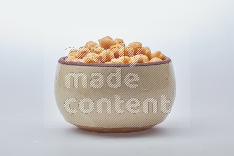 Close up of a boiled chickpeas in a container on white background