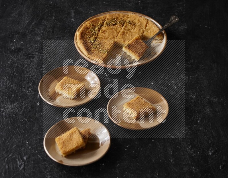 Konafa in different plates in a dark setup