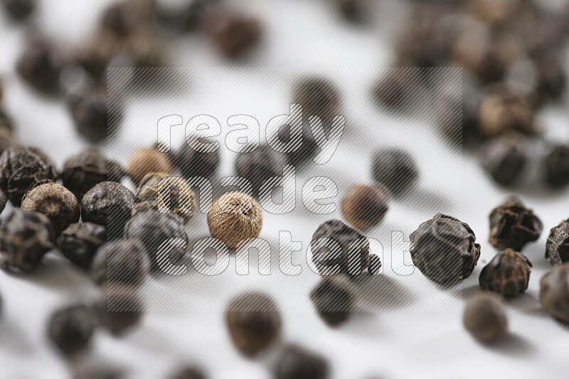 Black pepper beads on white background