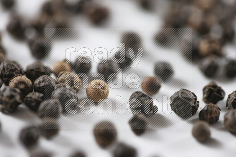 Black pepper beads on white background