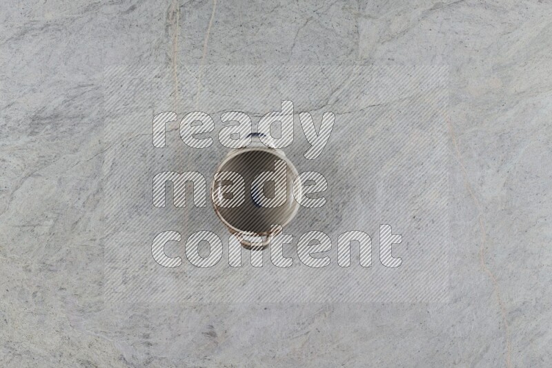 A multicolored pottery Bowl on grey marble background