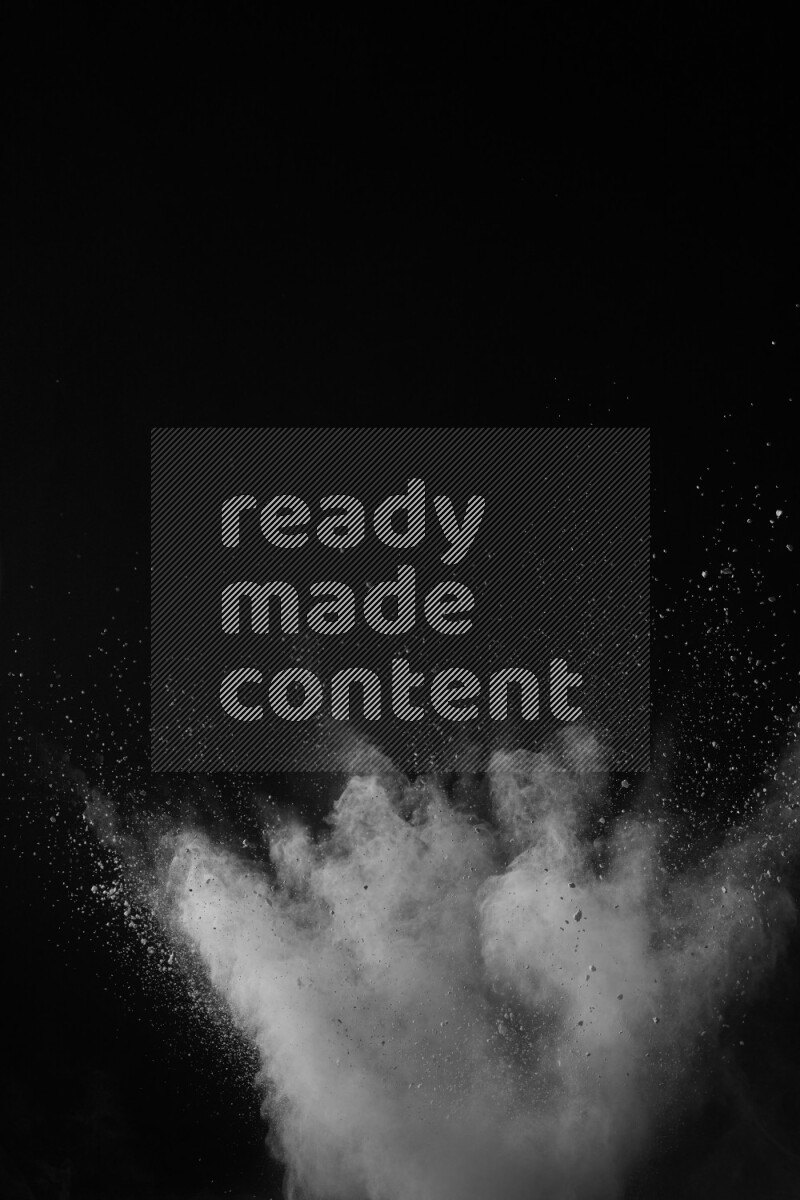 A side view of white powder explosion on black background