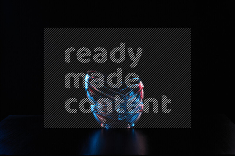 Glassware with rim light in red and blue against black background