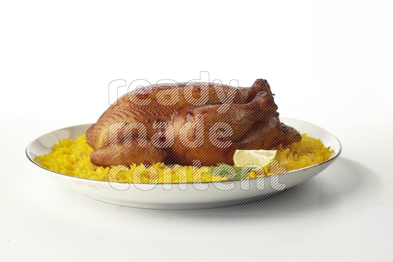 yellow  basmati Rice with kabsa chicken pieces on a white plate with a silver rim direct on white background