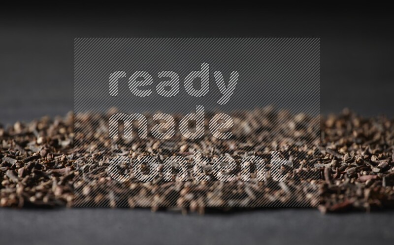 Cloves spread on black flooring