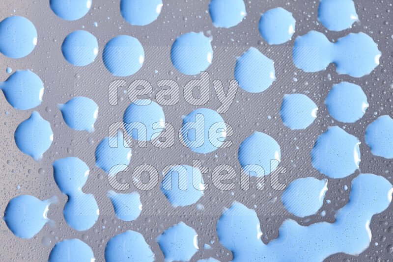Close-ups of abstract blue paint droplets on the surface