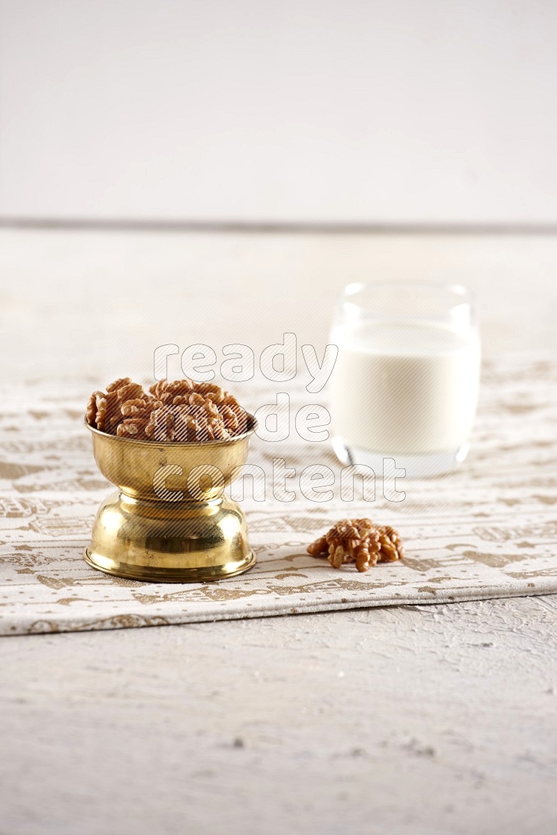 Nuts in a metal bowl with milk a light setup
