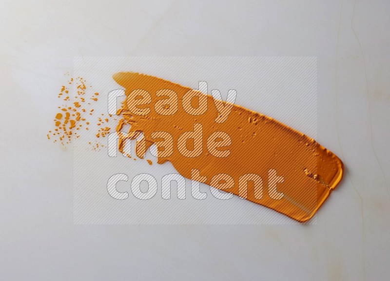 An orange straight painting knife stroke on white background