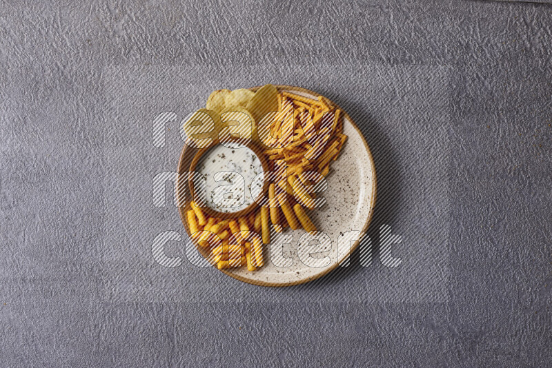 Assorted snacks in pottery bowls on grey background