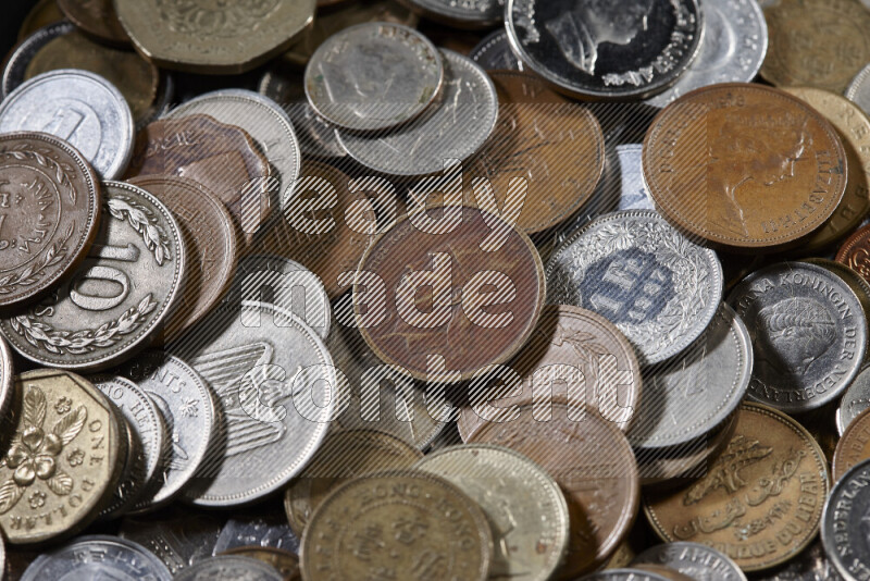 A close-ups of random old coins on black background
