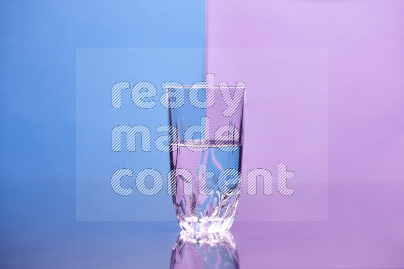 The image features a clear glassware filled with water, set against blue and light purple background