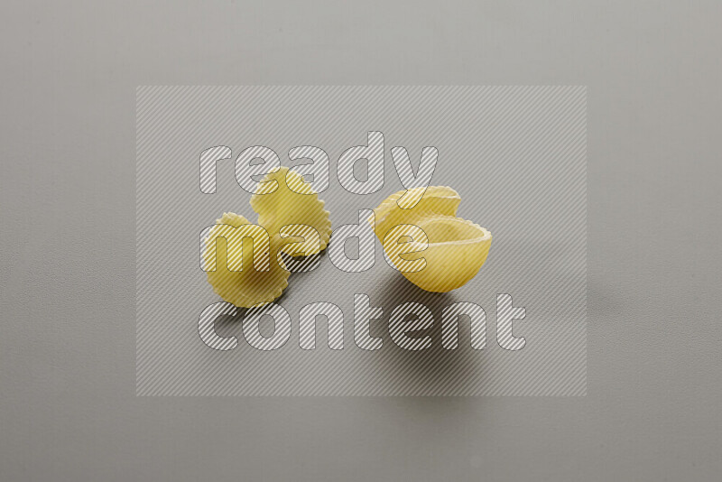 Fiocchi pasta with other types of pasta on grey background