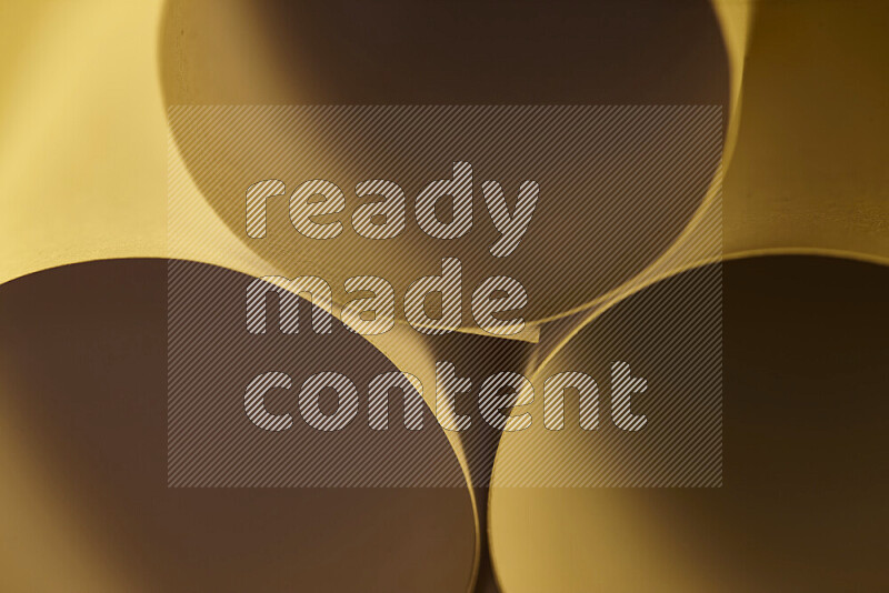 The image shows an abstract paper art with circular shapes in varying shades of gold