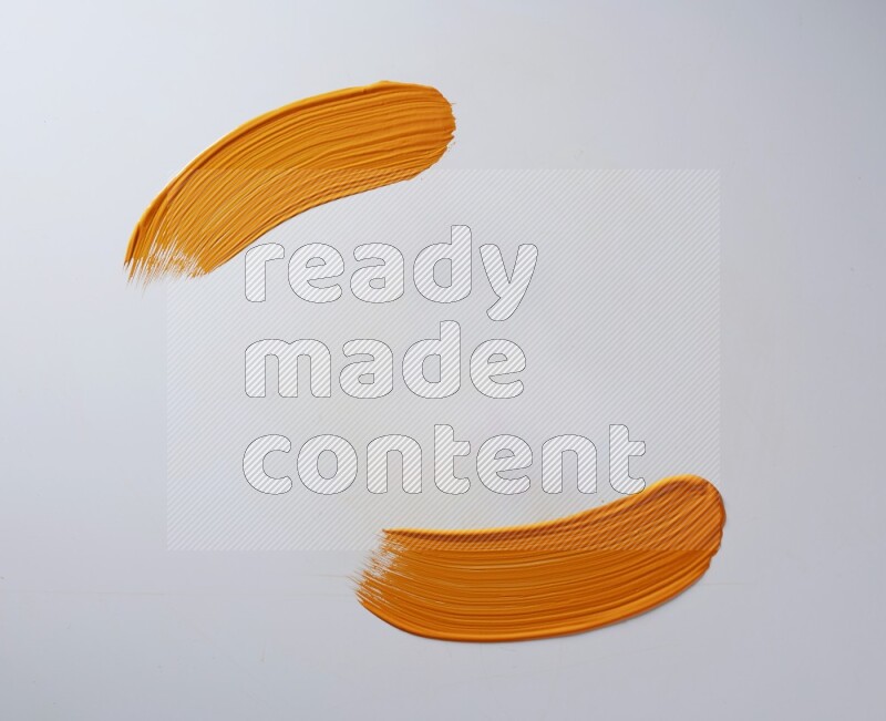 An orange curved painting brush stroke on a white background