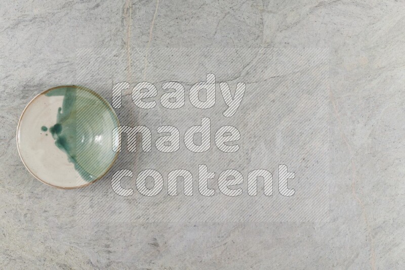 A multicolored pottery Bowl on grey marble background