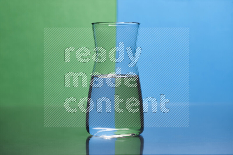 The image features a clear glassware filled with water, set against green and blue background