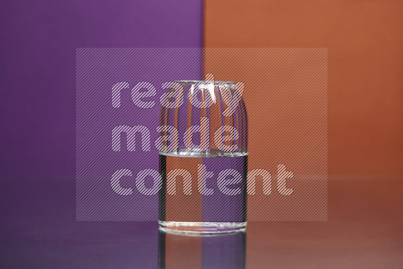 The image features a clear glassware filled with water, set against purple and dark orange background