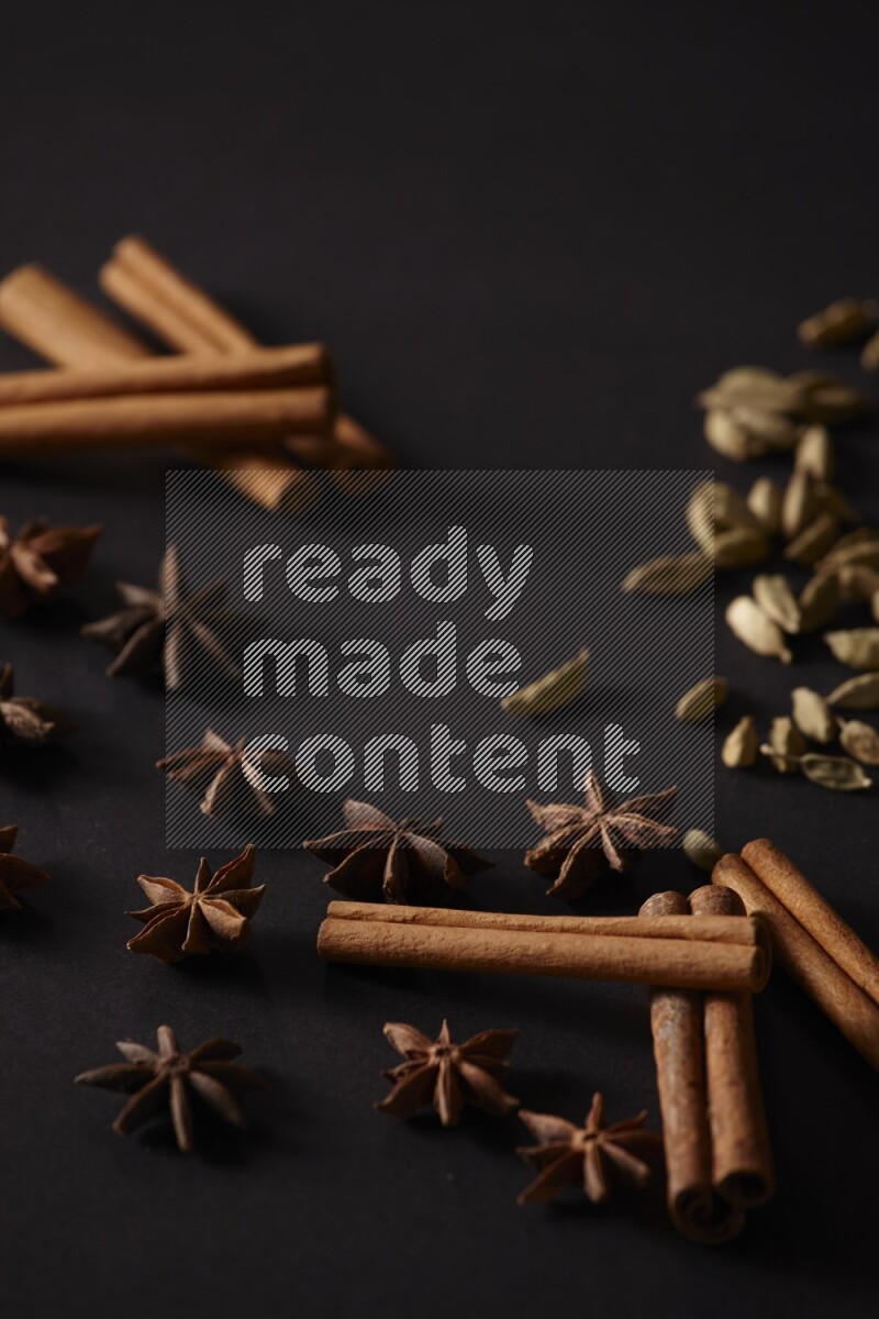Cinnamon Sticks, Cardamom and star anise on a black background