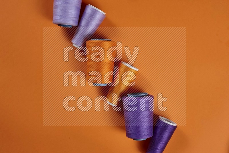Purple sewing supplies on orange background