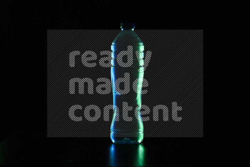 Water bottle with colored rim light against black background