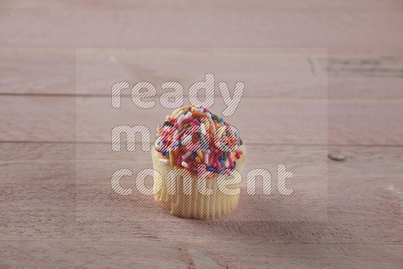 Vanilla mini cupcake topped with sprinkles