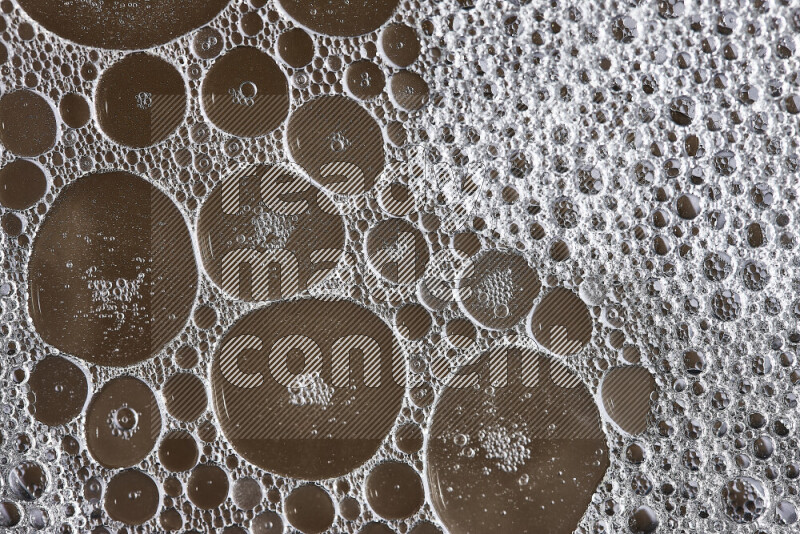 Close-ups of abstract soap bubbles and water droplets on brown background