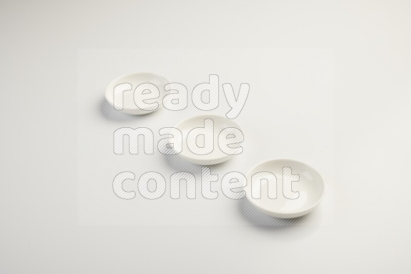 white ceramic round sauce dish on white countertop