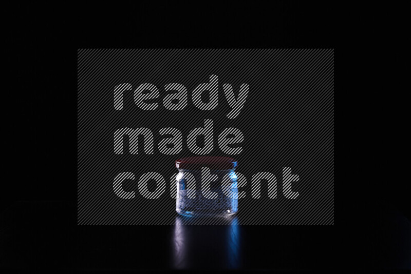 Glassware with rim light in blue and white against black background