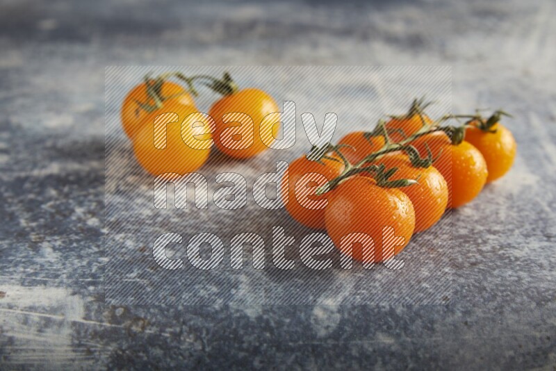 Mixed cherry tomato veins on a textured rustic blue background 45 degree