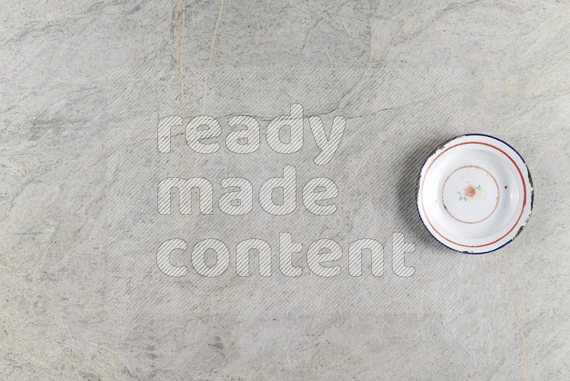 Top View Shot Of A Vintage Metal Plate On Grey Marble Flooring