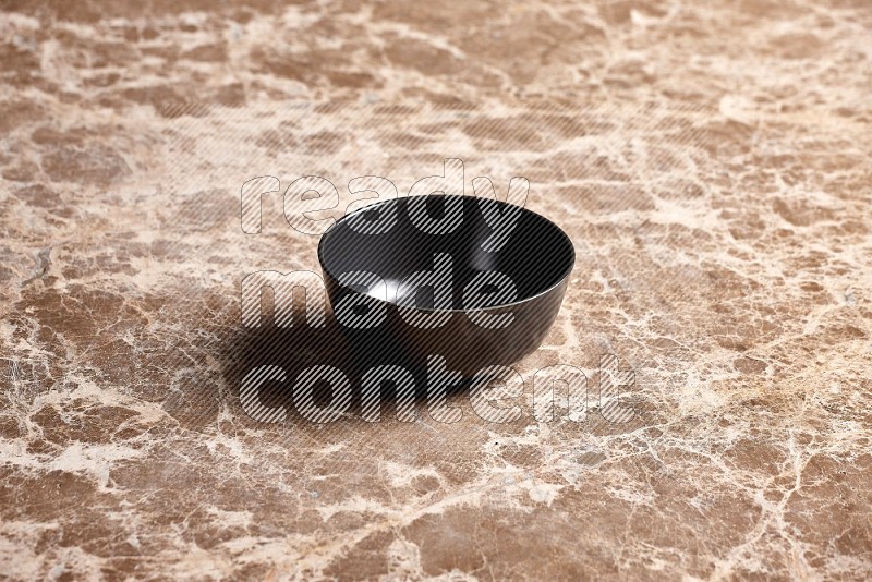 Black Ceramic Bowl on Beige Marble Flooring, 45 degrees