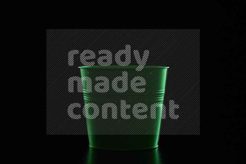 A plant pot with colored rim light against black background