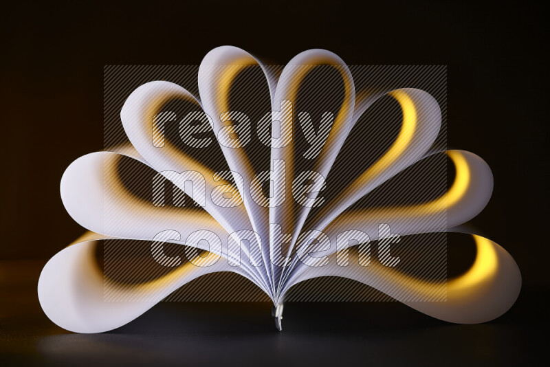 An abstract art piece displaying smooth curves in yellow and white gradients created by colored light
