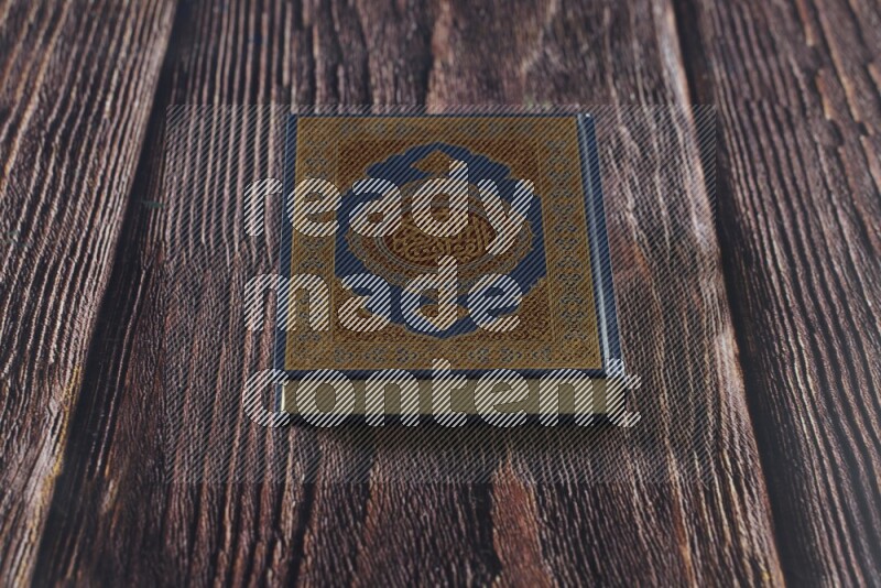 Quran with a prayer beads on wooden background