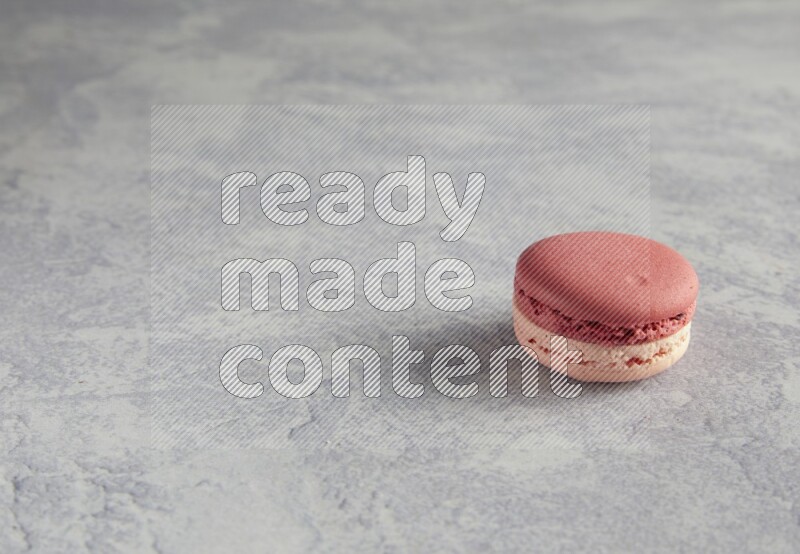45º Shot of Pink Litchi Raspberry macaron on white  marble background