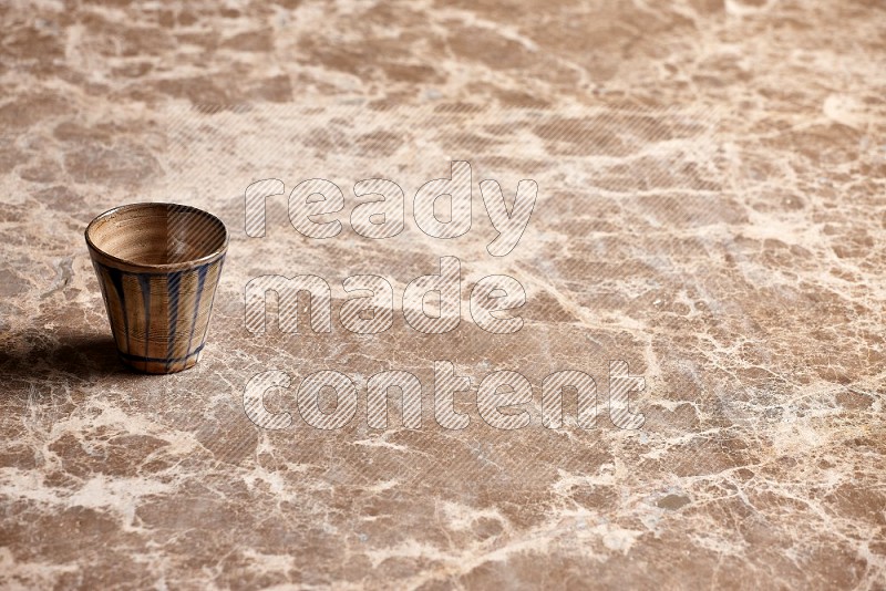 Pottery Cup on Beige Marble Flooring