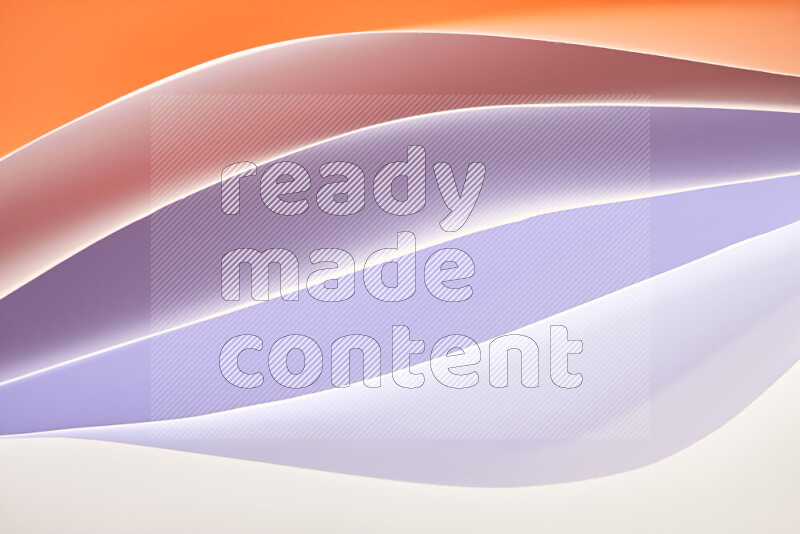 This image showcases an abstract paper art composition with paper curves in white and different warm gradients created by colored light
