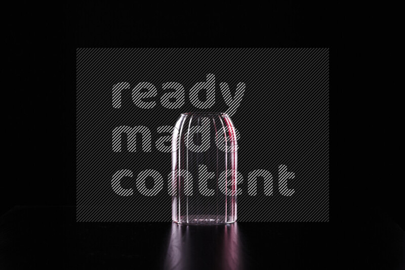 Glassware with rim light in red and white against black background