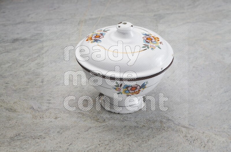A vintage metal pot on grey marble background