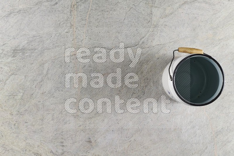 Top View Shot Of A Vintage Milk Can On Grey Marble Flooring