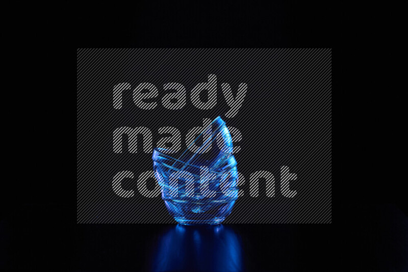 Glassware with rim light in blue against black background