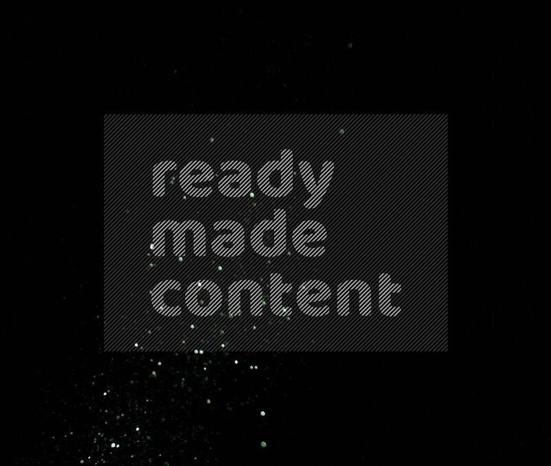 Green glitter powder isolated on black background