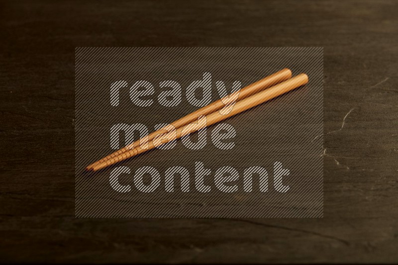 wooden chopsticks on black slate background