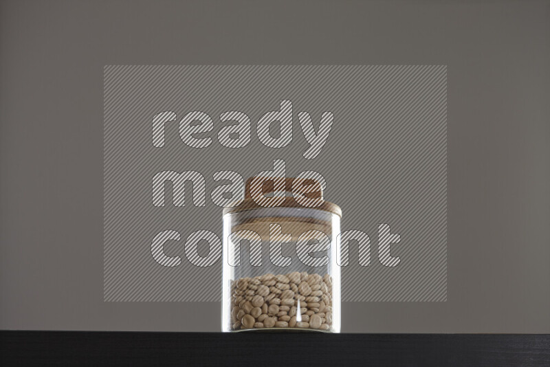 Lupin Beans in a glass jar on black background