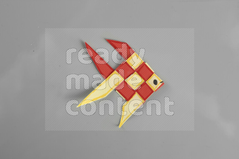 Origami fish on grey background