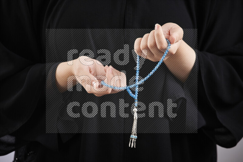 Woman hands holding praying beads (sebha) in different positions